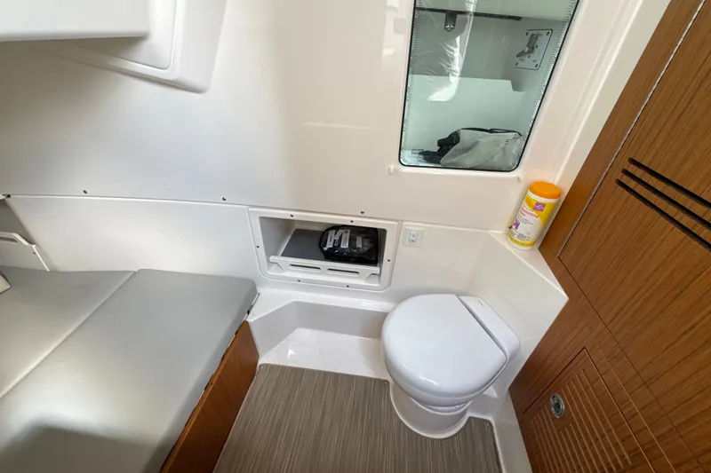 Slide: The Image of Modern bathroom interior of 2026 Solace 32CS boat, featuring toilet and storage. - 24