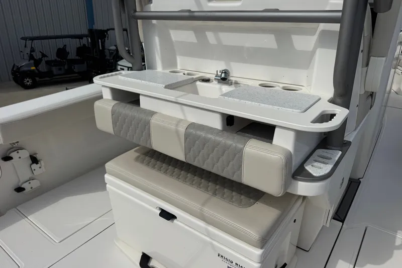 Slide: The Image of 2026 Solace 32CS boat interior with cushioned seating and utility station. - 11