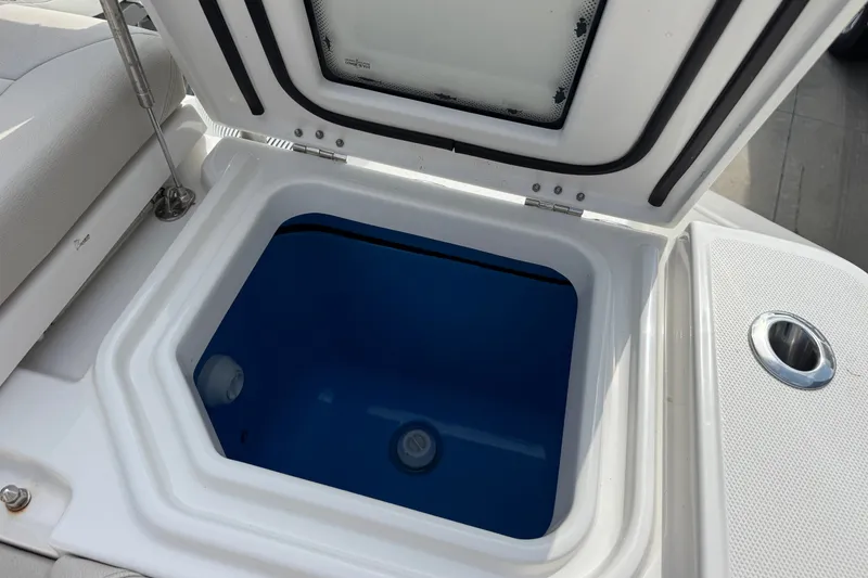 Slide: The Image of Open storage compartment on 2026 Solace 32CS boat, featuring a blue interior. - 8