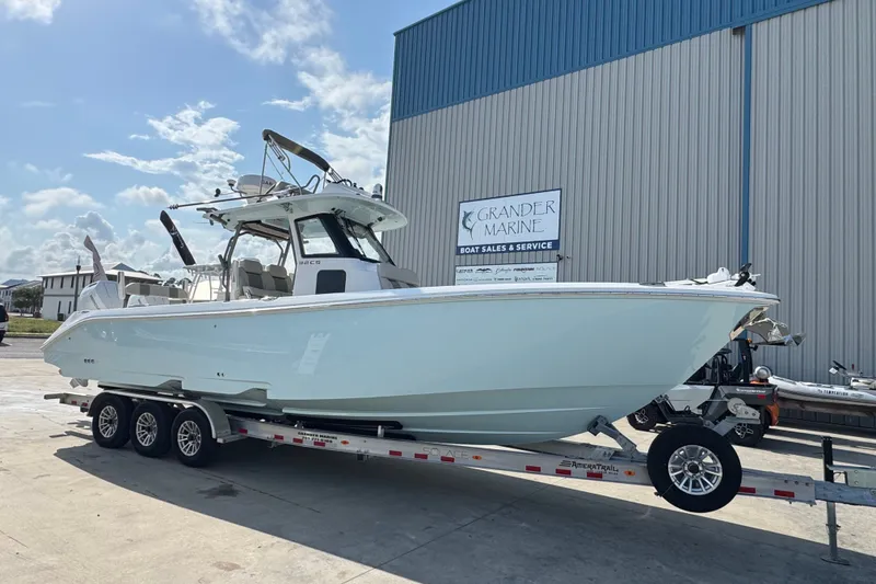 The Image of 2026 Solace 32CS boat on trailer at Grander Marine dealership. - 1