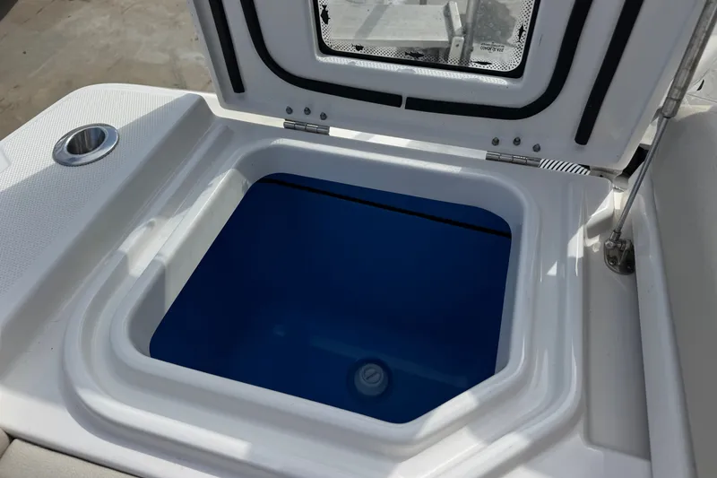 Slide: The Image of Open hatch on 2026 Solace 32CS boat, revealing blue interior compartment. - 9