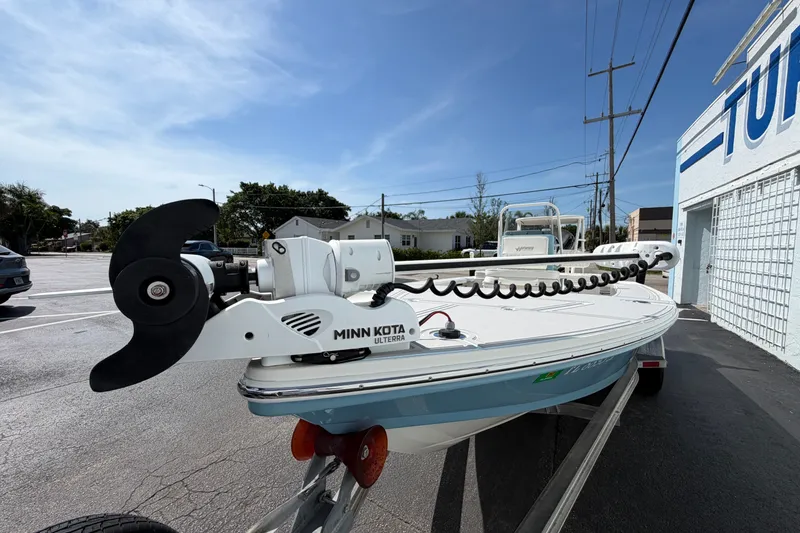 Slide: The Image of 2020 Hewes Redfisher 18 boat with Minn Kota motor on trailer, parked outdoors. - 14