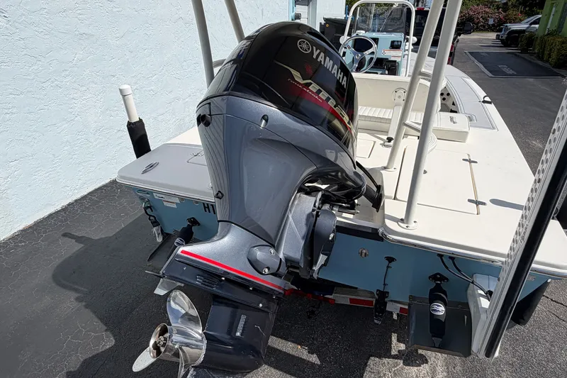 Slide: The Image of 2020 Hewes Redfisher 18 boat with Yamaha outboard motor, parked on a trailer. - 11