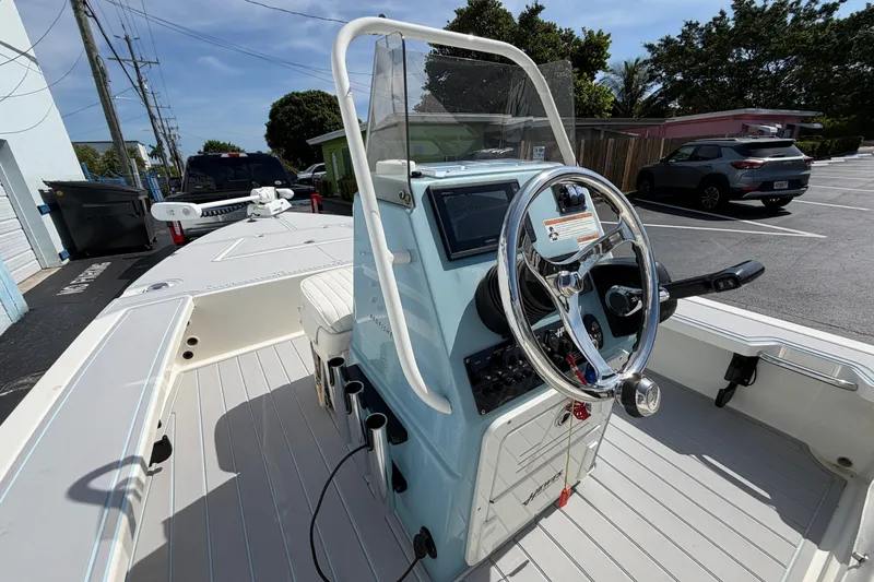 Slide: The Image of 2020 Hewes Redfisher 18 boat with steering console, parked outdoors. - 13