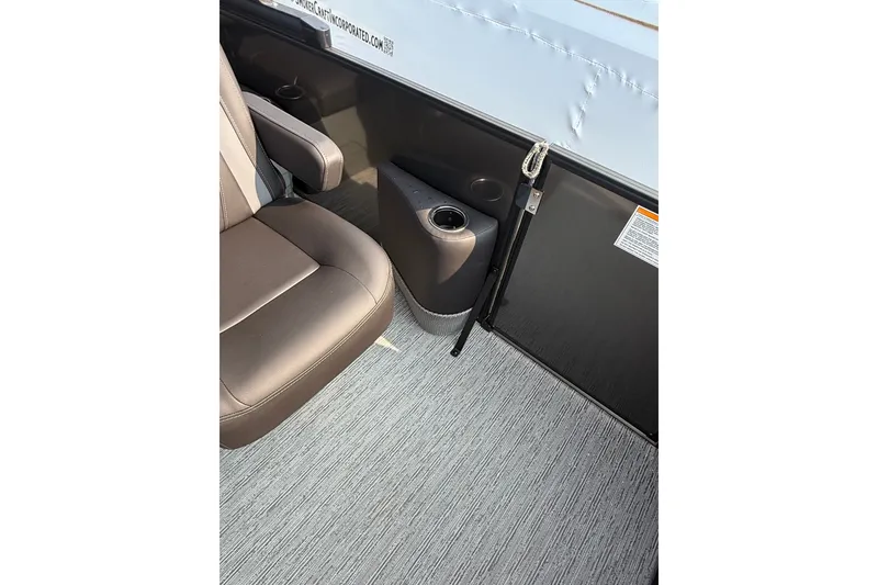 Slide: The Image of Interior of 2026 Sylvan X1 CLZ DH boat with brown seating and cup holder. - 22