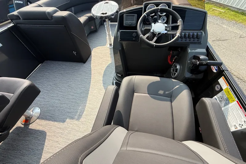 Slide: The Image of Interior view of 2026 Sylvan X1 CLZ DH boat, featuring modern steering and seating. - 11