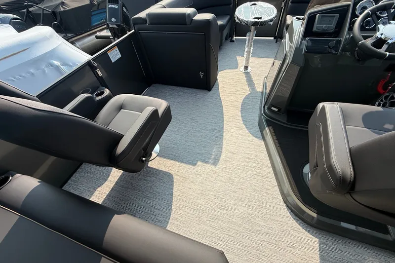 Slide: The Image of Interior of 2026 Sylvan X1 CLZ DH boat with modern seating and dashboard. - 12