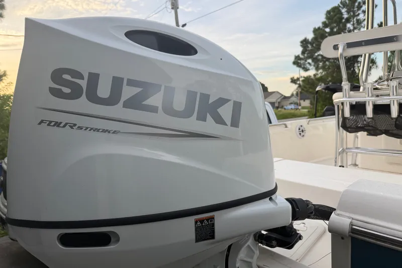 Slide: The Image of 2025 Bulls Bay 2200 XS boat with Suzuki four-stroke engine, outdoor setting. - 7