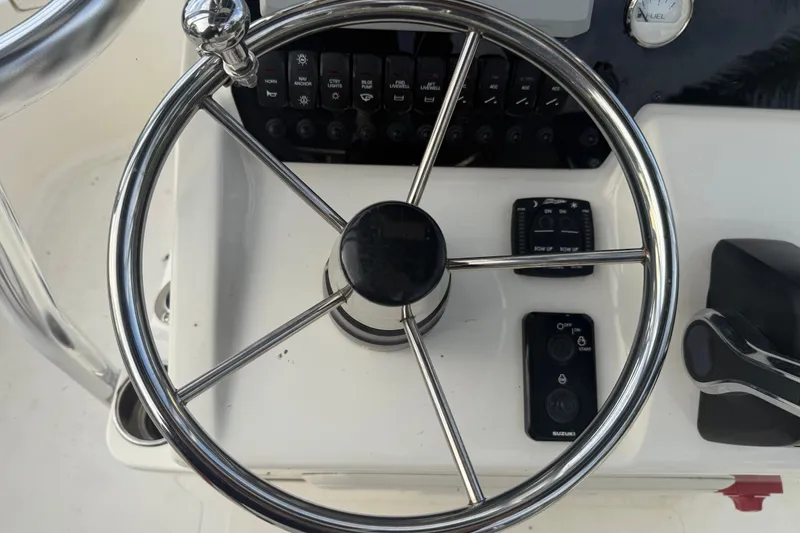 Slide: The Image of Steering wheel and controls of 2025 Bulls Bay 2200 XS boat cockpit. - 19