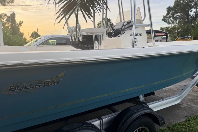 Slide: The Image of 2025 Bulls Bay 2200 XS boat on trailer, side view at sunset. - 1