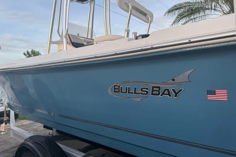 Slide: The Image of 2025 Bulls Bay 2200 XS boat with logo and American flag decal. - 3