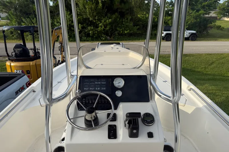 Slide: The Image of 2025 Bulls Bay 2200 XS boat dashboard with steering wheel and controls. - 15
