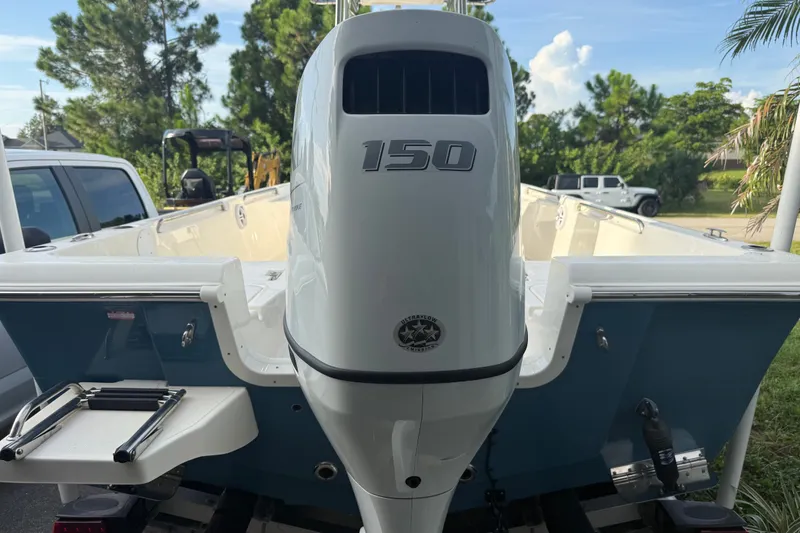 Slide: The Image of 2025 Bulls Bay 2200 XS boat with 150 horsepower engine, parked outdoors. - 6