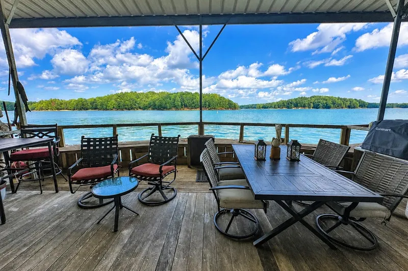 Slide: The Image of Covered deck on 1999 Sumerset 16x75 houseboat with lake view and outdoor seating. - 17