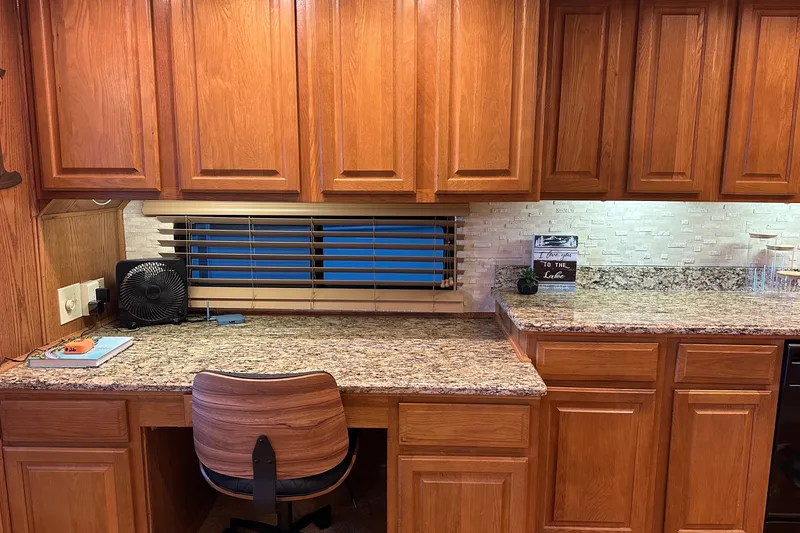 Slide: The Image of Wooden cabinetry and granite countertop in a Sumerset 16x75 houseboat, 1999 model. - 5