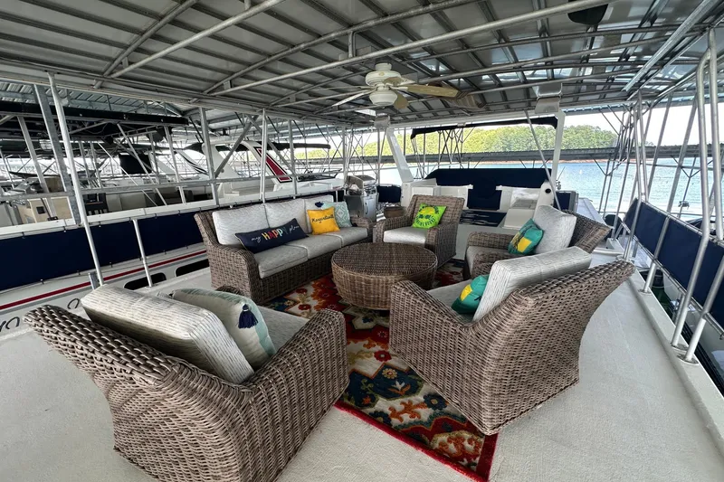 Slide: The Image of Spacious 1999 Sumerset 16x75 houseboat deck with wicker furniture and colorful cushions. - 14