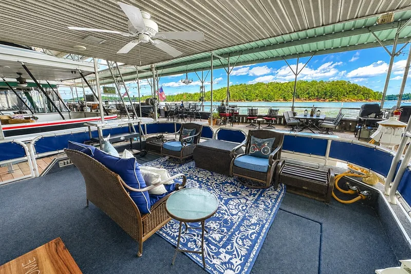 Slide: The Image of Spacious 1999 Sumerset 16x75 houseboat deck with seating, ceiling fan, and scenic lake view. - 1