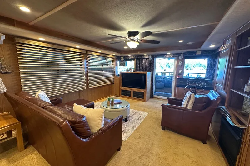 Slide: The Image of Luxurious 1999 Sumerset 16x75 houseboat interior with leather seating and entertainment area. - 3