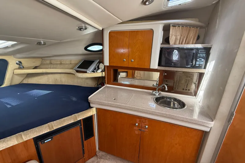 Slide: The Image of 2003 Regal Commodore 2860 cabin interior with kitchenette and bed. - 9