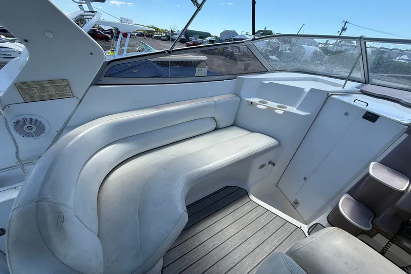 Slide: The Image of 2003 Regal Commodore 2860 boat interior with cushioned seating and cup holders. - 6