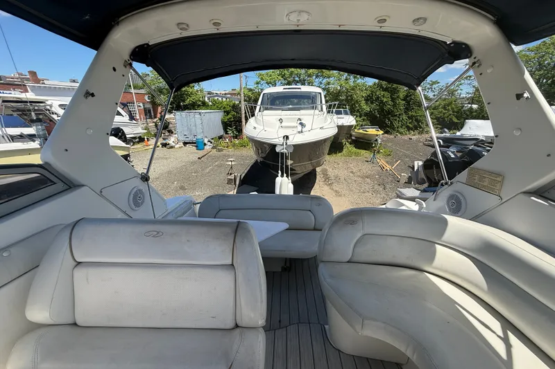 Slide: The Image of 2003 Regal Commodore 2860 boat interior with seating, docked outdoors. - 4