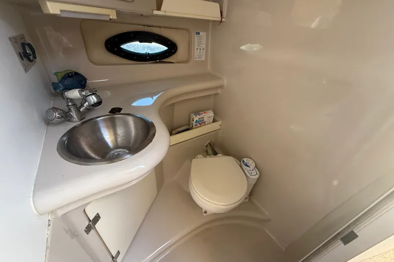 Slide: The Image of Compact bathroom in 2003 Regal Commodore 2860 boat with sink and toilet. - 11