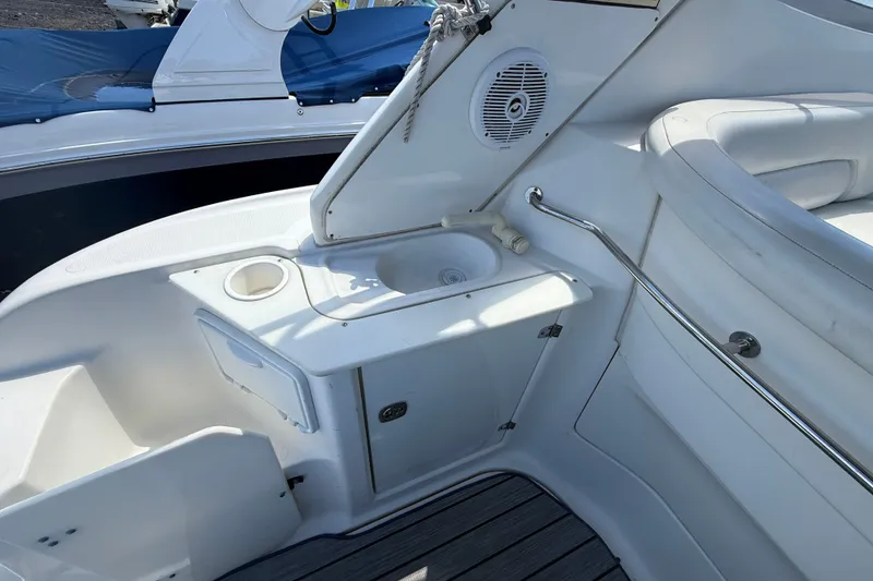 Slide: The Image of 2003 Regal Commodore 2860 boat interior with sink and seating area. - 3