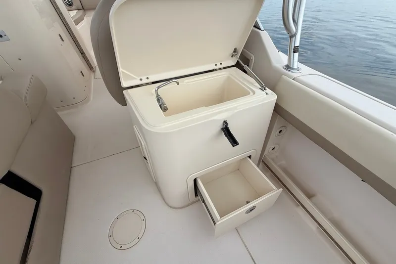 Slide: The Image of Grady-White Freedom 275 boat interior with open storage compartment and sink, 2013 model. - 18