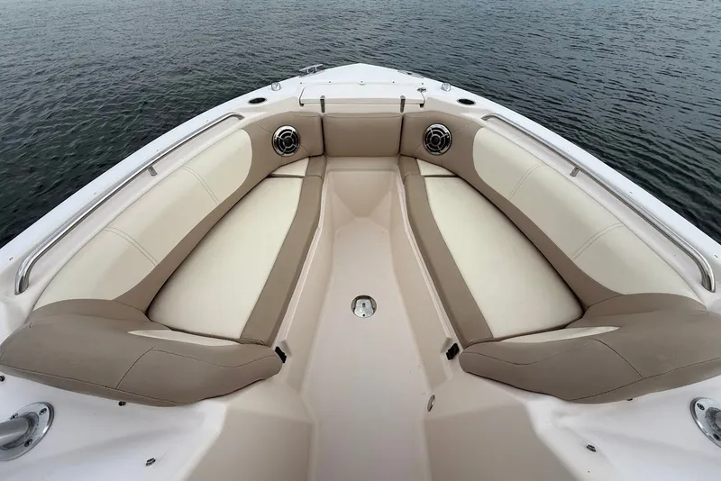 Slide: The Image of 2013 Grady-White Freedom 275 boat interior with cushioned seating and water view. - 29