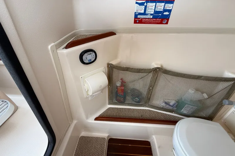 Slide: The Image of 2013 Grady-White Freedom 275 boat interior with storage and toilet area. - 23
