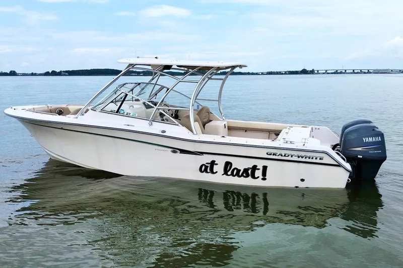 The Image of 2013 Grady-White Freedom 275 boat on calm water with Yamaha engine. - 1