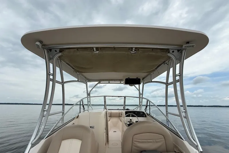 Slide: The Image of 2013 Grady-White Freedom 275 boat interior with canopy on calm water. - 16