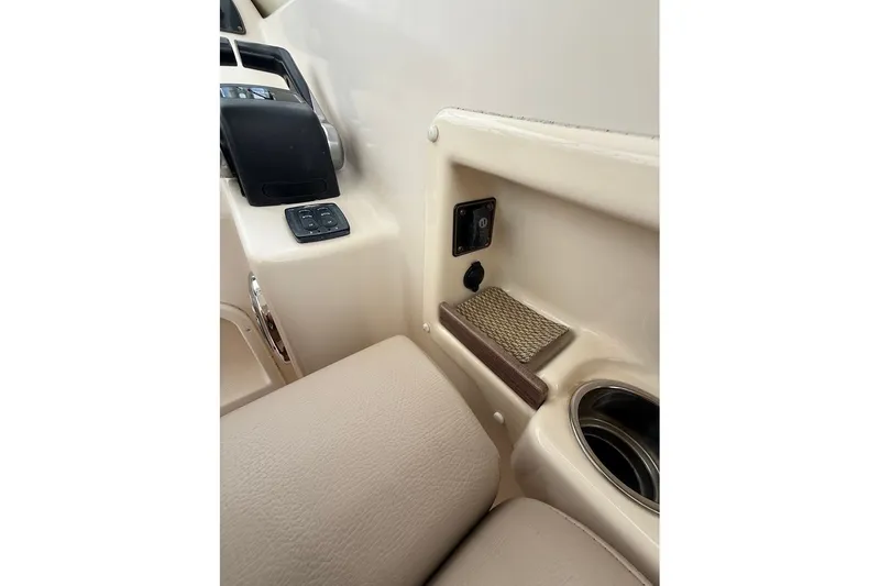 Slide: The Image of Interior view of 2013 Grady-White Freedom 275 boat, featuring control panel and cup holder. - 34