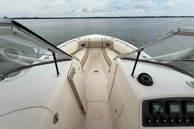 Slide: The Image of 2013 Grady-White Freedom 275 boat interior with open windshield on calm water. - 28