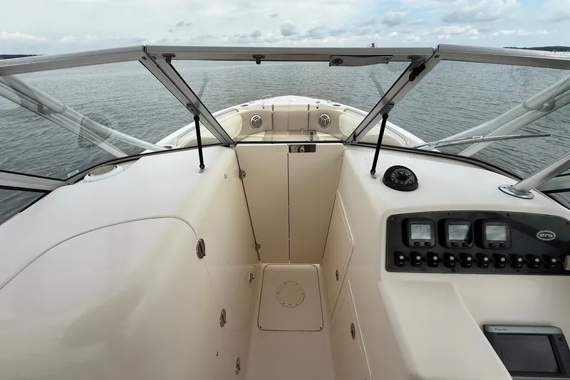 Slide: The Image of 2013 Grady-White Freedom 275 boat dashboard with open water view. - 27