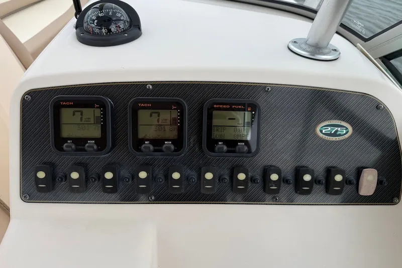 Slide: The Image of Dashboard of 2013 Grady-White Freedom 275 boat with gauges and switches. - 26