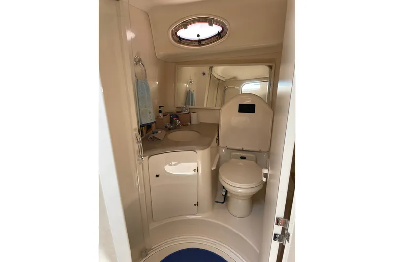 Slide: The Image of Bathroom interior of 1997 Sea Ray 370 Express Cruiser with sink and toilet. - 13