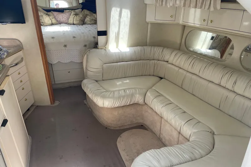 Slide: The Image of Interior of 1997 Sea Ray 370 Express Cruiser with plush seating and cozy bedroom. - 15