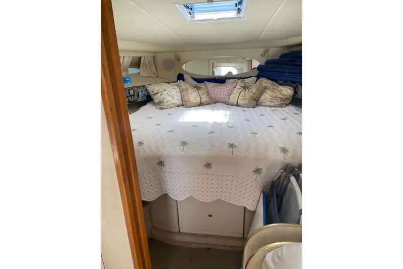 Slide: The Image of Cozy cabin interior of 1997 Sea Ray 370 Express Cruiser with decorative pillows. - 16