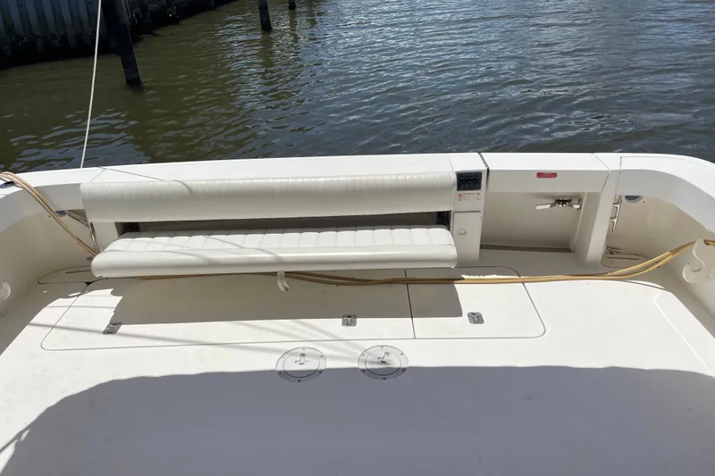 Slide: The Image of 1997 Sea Ray 370 Express Cruiser deck with white seating and water view. - 11