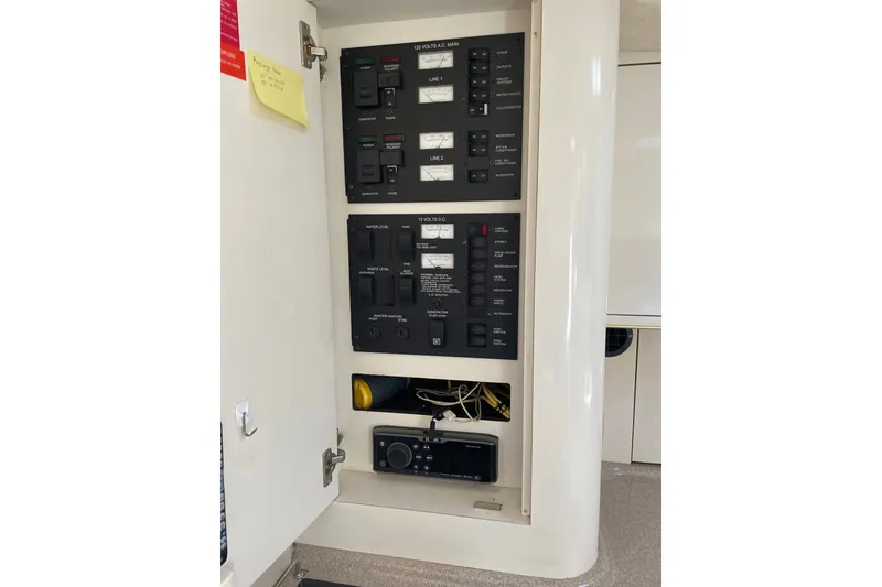 Slide: The Image of Electrical panel inside a 1997 Sea Ray 370 Express Cruiser, showcasing switches and controls. - 14