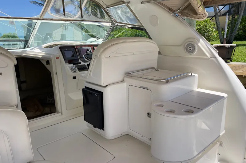 Slide: The Image of 1997 Sea Ray 370 Express Cruiser interior with helm, seating, and storage compartments. - 10