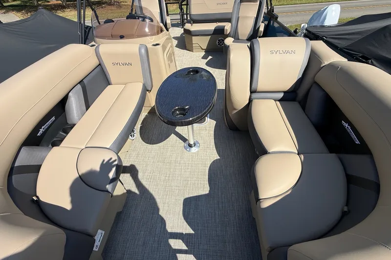 Slide: The Image of Luxurious interior of 2026 Sylvan X-3 CLZ DH pontoon boat with plush seating and table. - 16