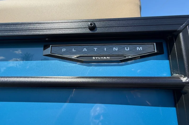 Slide: The Image of 2026 Sylvan X-3 CLZ DH Platinum badge on blue exterior. - 28