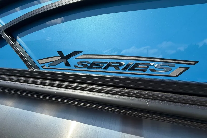 Slide: The Image of 2026 Sylvan X-3 CLZ DH boat with blue "X Series" branding detail. - 27