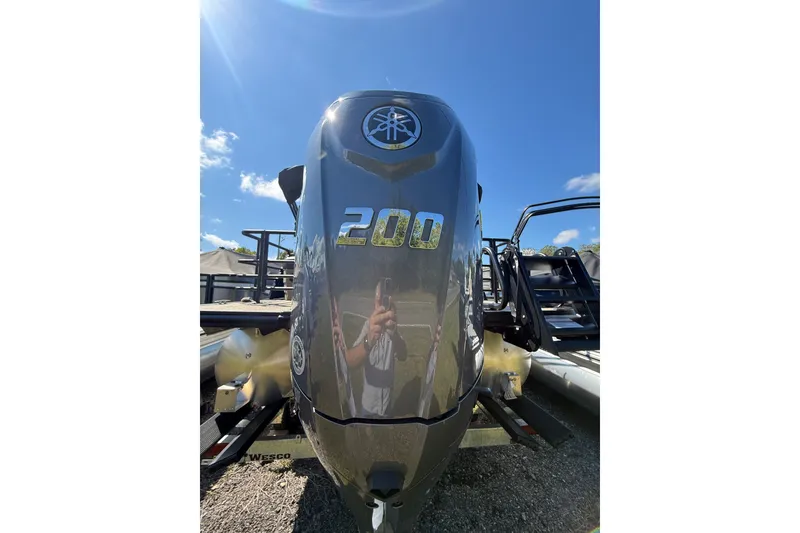 Slide: The Image of Outboard motor on Sylvan X-3 CLZ DH 2026 boat under clear blue sky. - 26