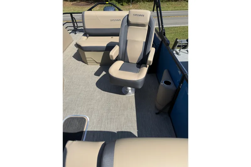 Slide: The Image of 2026 Sylvan X-3 CLZ DH boat interior with beige seating and cup holder. - 18
