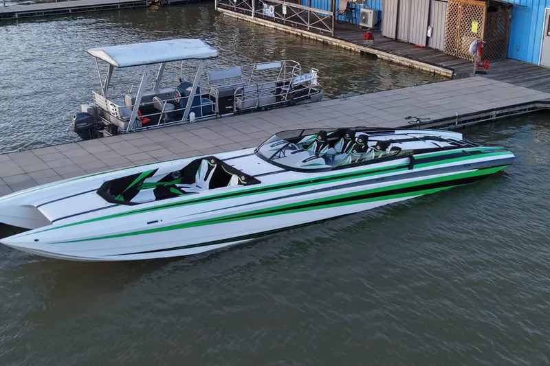 The Image of 2022 Daves Custom Boats M-44 docked, featuring sleek design and vibrant green accents. - 0