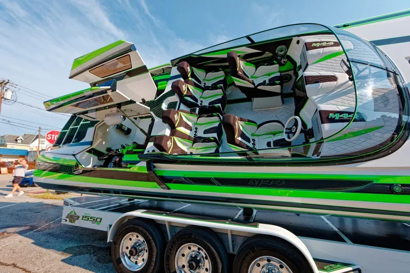 Slide: The Image of 2022 Daves Custom Boats M-44 with vibrant green and black design on trailer. - 4