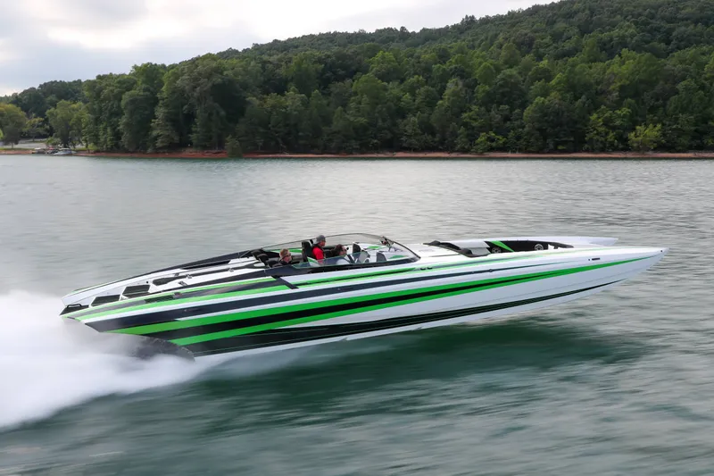 Slide: The Image of 2022 Daves Custom Boats M-44 speeding on a lake with lush forest backdrop. - 42
